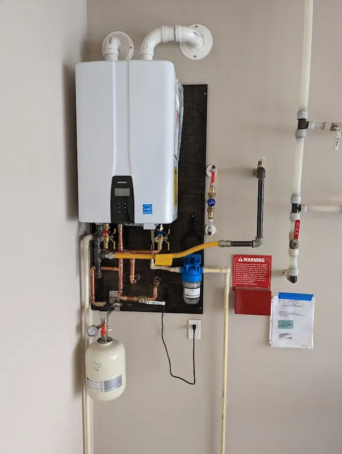 Professional plumber installing copper piping in a Great Neck home